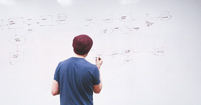 teacher writing on whiteboard