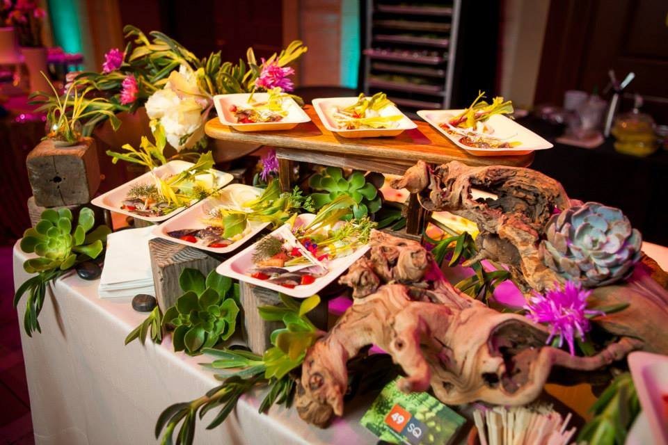 49 Square Catering uses succulents, flowers, and rustic wood pieces to amp up their presentation.