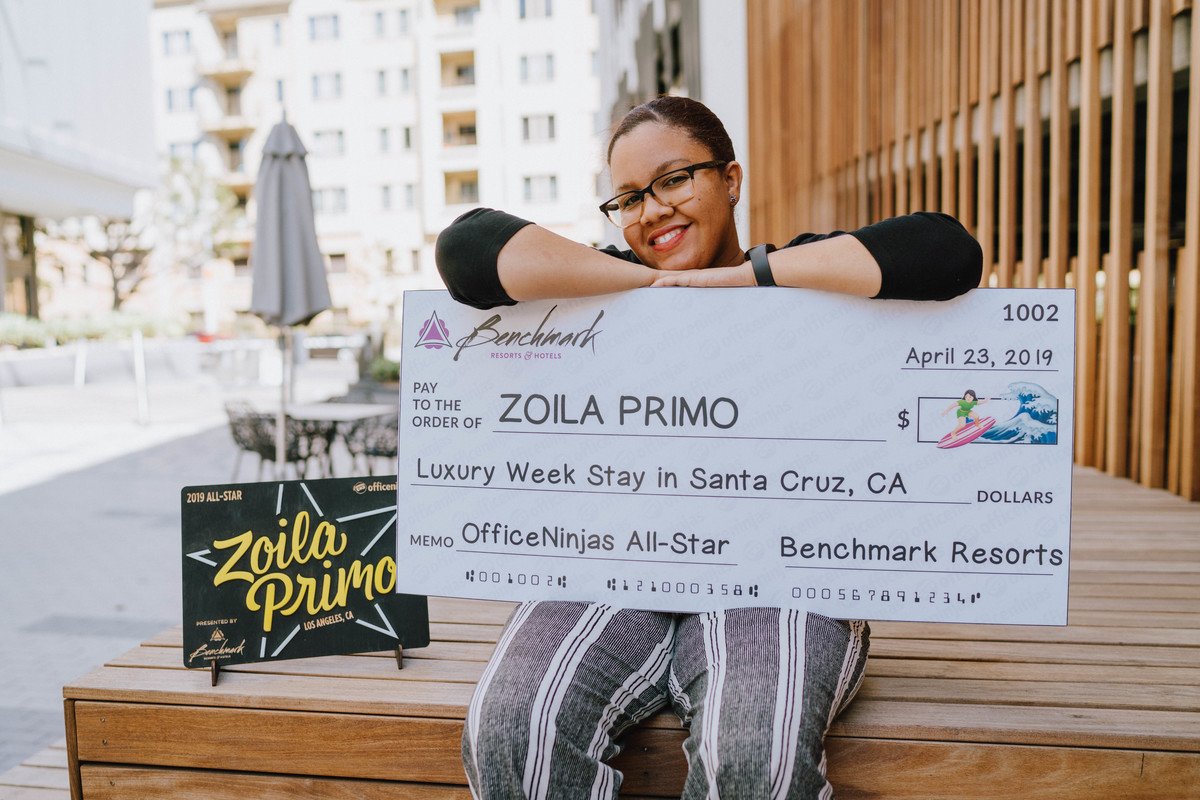 Zoila with part of her winnings from Admin Week 2019 partner, Benchmark Resorts.